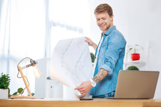 istock Positive smart worker smiling while looking at the laptop 905535996