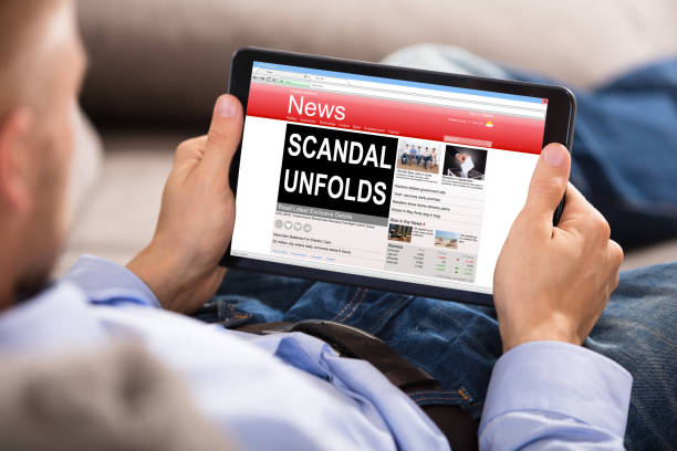istock Man Reading Unfolds Scandal News On Digital Tablet 905536958