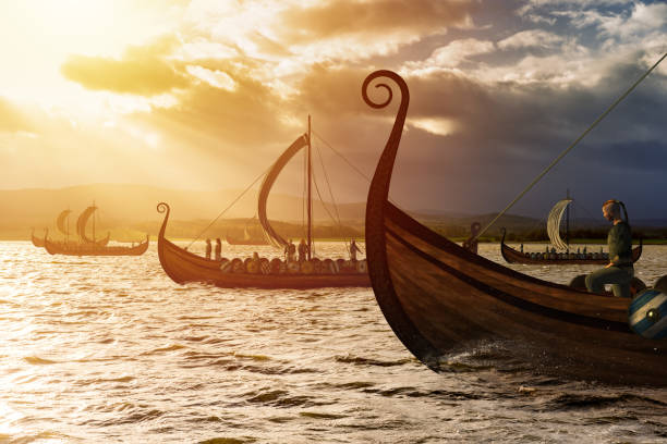 корабли викингов на воде под солнечным светом и темным штормом - viking стоковые фото и изображения