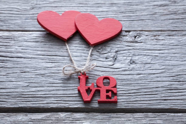 istock Valentine day background, handmade hearts on wood with copy space 905540602