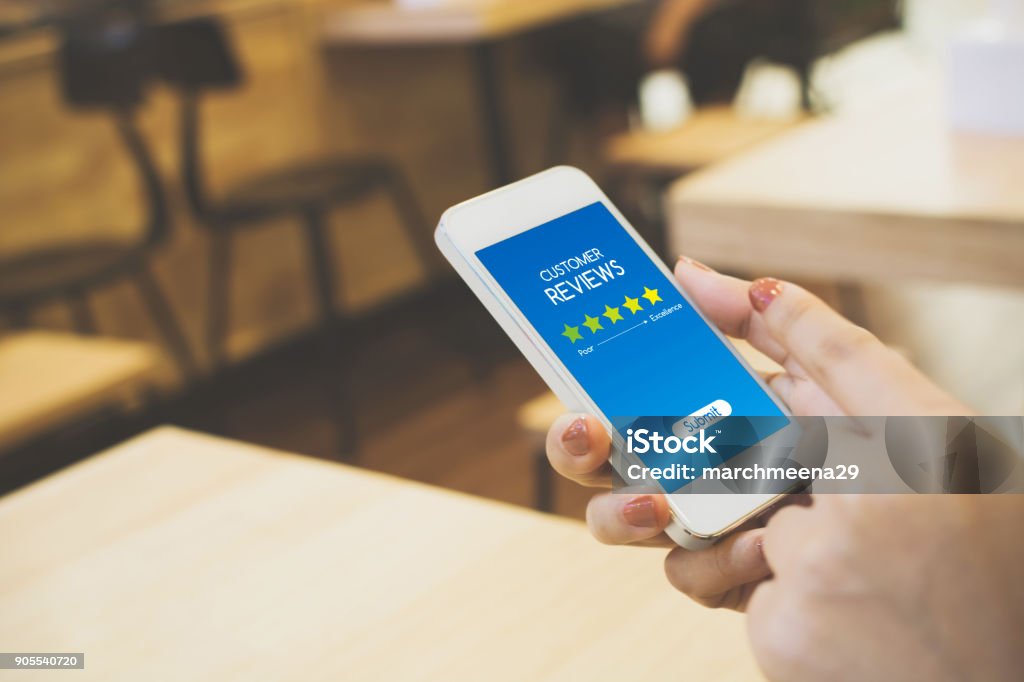Customer review rating business concept, Woman hand using mobile phone Rating Stock Photo