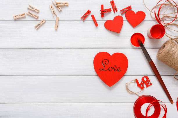 istock Valentine day diy handmade hearts making, top view on wood 905545134