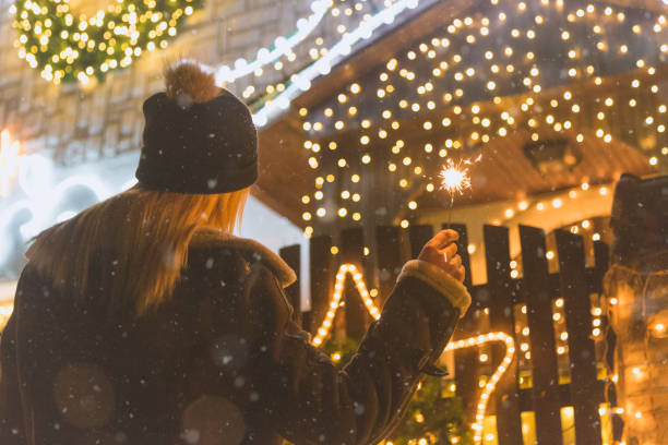 istock Female enjoying Christmas eve outdoors with sparklers 905552308