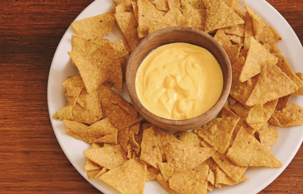 istock Top view of nachos with cheese dip 905554278