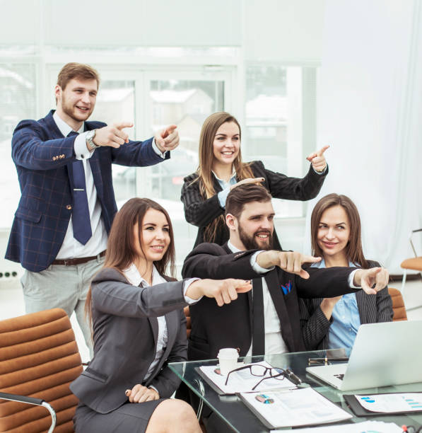 istock success concept in business - friendly business team showing forefinger forward 905559824