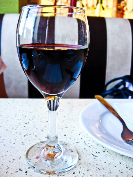 the image of glass of red wine on the table