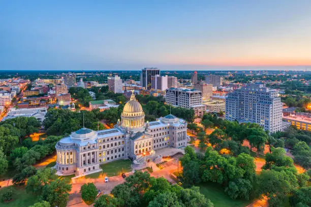 Jackson, Mississippi, USA downtown skyline over the capitol at dusk.