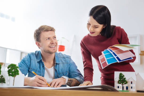 istock Pretty woman looking at the drawing while a man looking at her 905568254