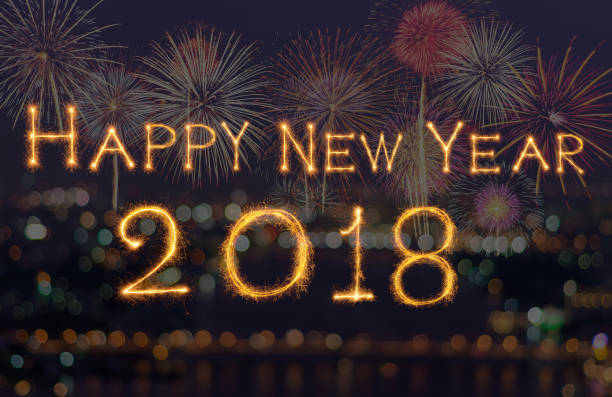 istock Happy new year 2018 written with Sparkle firework on fireworks with dark background, celebration and greeting cards concept 905568954