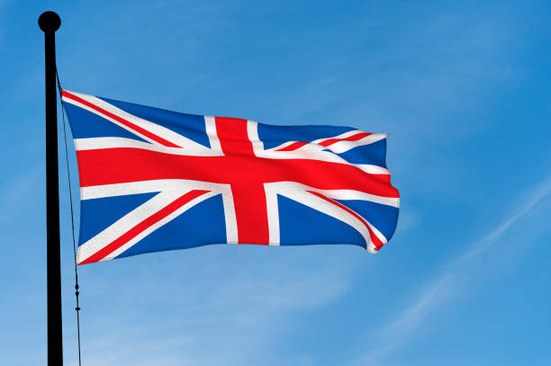 istock UK Flag waving over blue sky (digitally generated image) 905576032