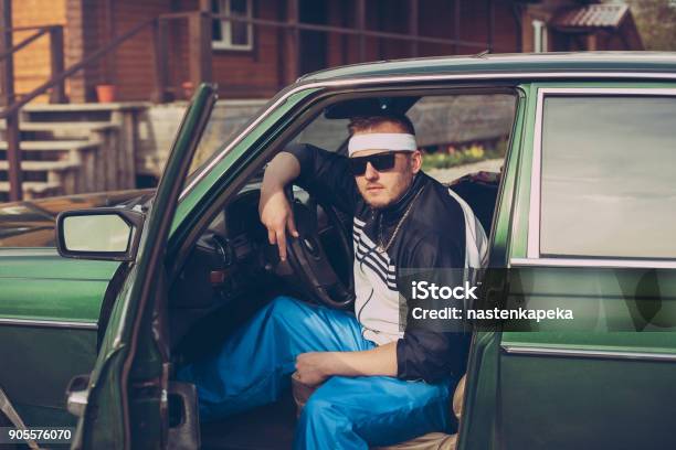 Guy In The Nineties Sits Behind The Wheel Of A Car Stock Photo - Download Image Now - 1990-1999, 1990, Men