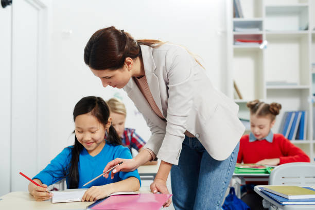istock Teacher and schoolgirl 905579082