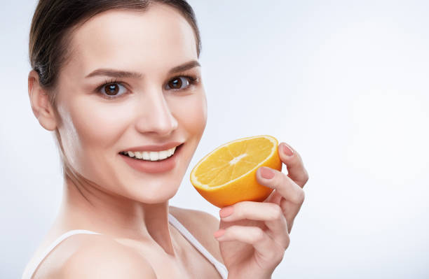 istock Smiling beautiful girl with lemon 905579722