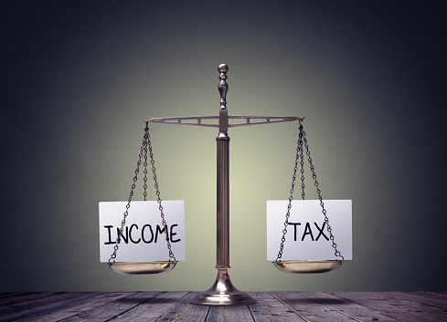 Income tax balance finance books scales concept