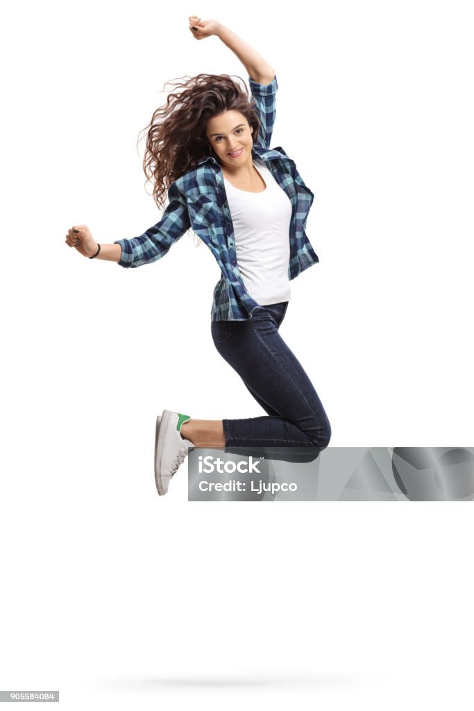 Overjoyed teen girl jumping and gesturing happiness Overjoyed teen girl jumping and gesturing happiness isolated on white background Jumping Stock Photo