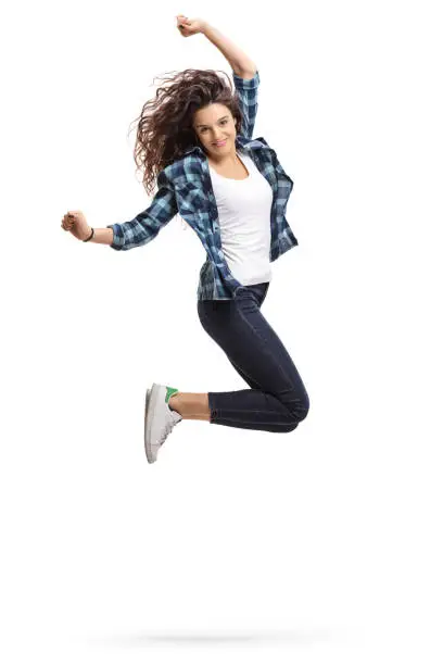 Overjoyed teen girl jumping and gesturing happiness isolated on white background