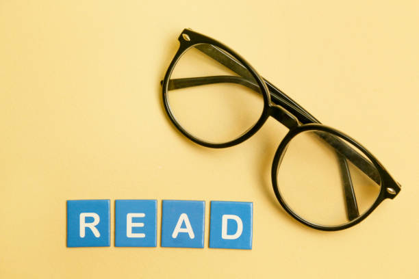 istock Reading glasses with letters around - love reading concept 905586364