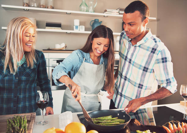istock Happy friends fry asparagus. 905591064