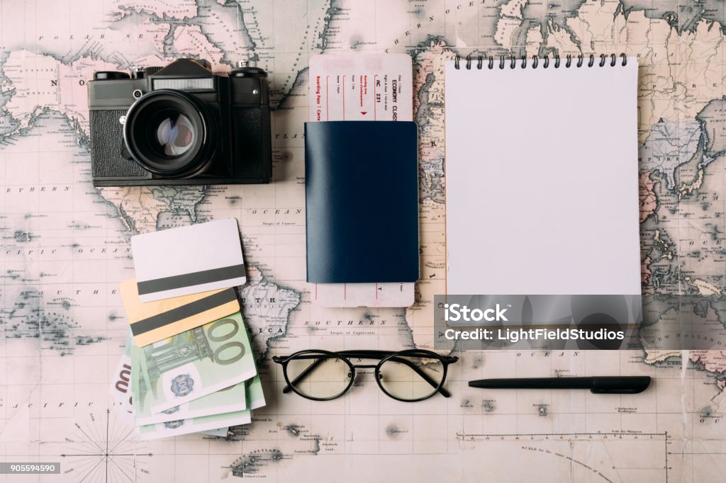 tourism Flat lay of passport with ticket and money with credit cards on a map. tourism concept Map Stock Photo