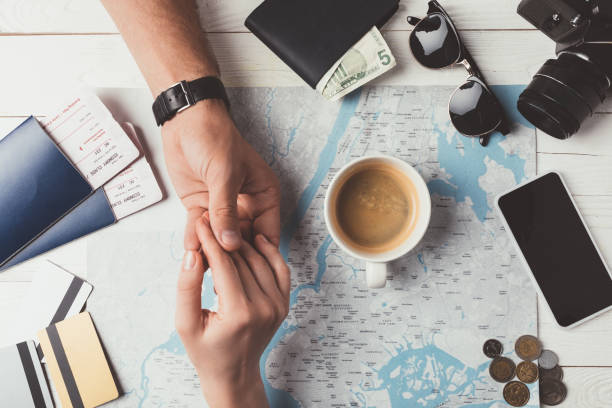 istock couple holding hands and planning travel 905594718