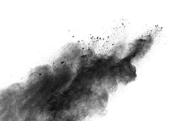 istock Black powder explosion against white background.The particles of charcoal splatted on white background. Closeup of black dust particles explode isolated on white background. 905595358