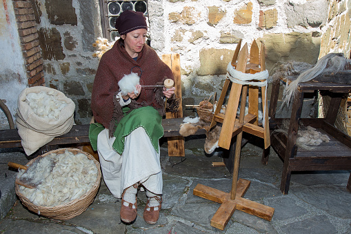 Gorizia, Italy - April 23, 2017: Medieval craftsman with Raw Sheep Wool in vintage clothes on on historical reenactment in Gorizia, Italy.