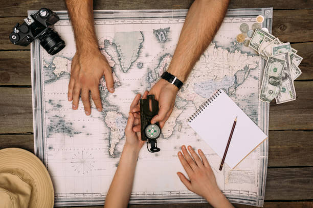 istock couple planning travel and looking at compass 905598944