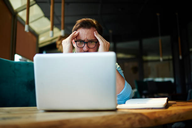 istock Depressed male entrepreneur feeling headache can't solve problems with finance checking report on netbook.Stressed manager worried about documentation on laptop failure with saving on software 905600112