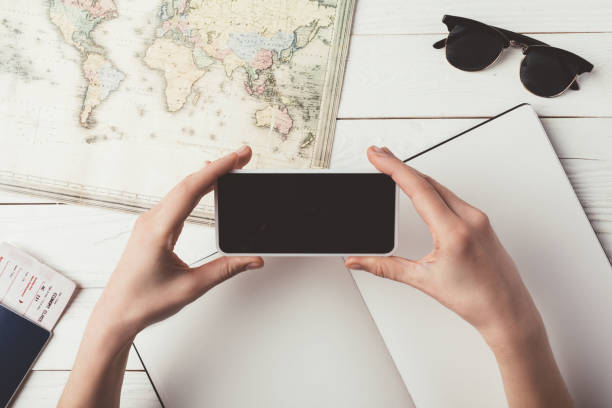 istock woman taking photo of map 905600258