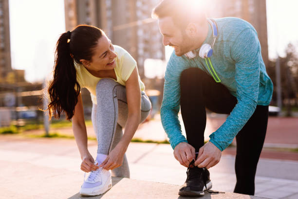 istock Runners tying running shoes and getting ready to run 905603536