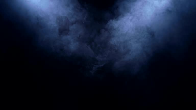 Smoke clears in the spotlight on black background