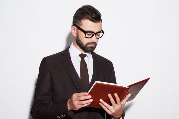 istock Attractive man at white background in suit 905608332