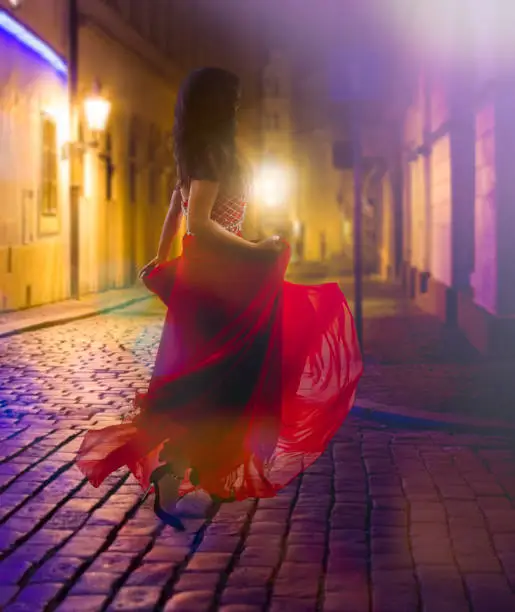 Woman on white in red dress running in europe