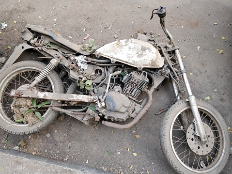 Close-up of rusted old motorcycle on the ground