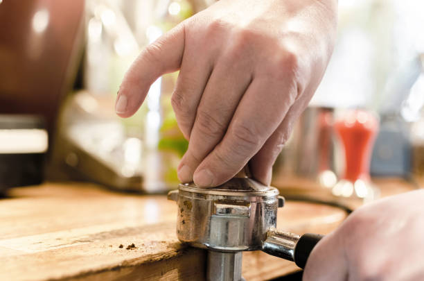 istock pressing coffee with the tamper in portafilter 905622890