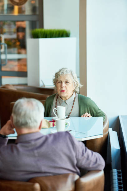 istock Content senior wife spending leisure with husband in cafe 905627432