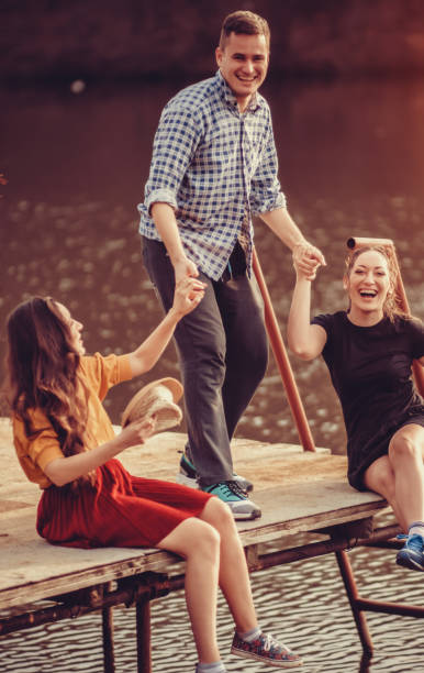 istock Friends Hanging Out, Sitting on Pier 905630520