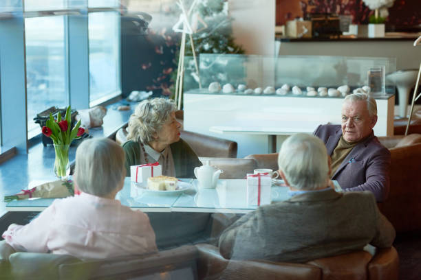 istock Serious senior friends discussing relevant topics at lunch 905631976