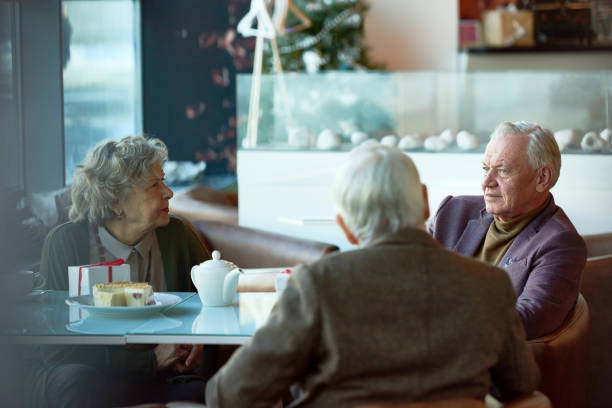 istock Senior friends enjoying communication in cafe 905631982