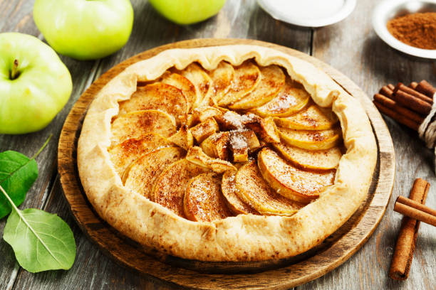 Galette with apples and cinnamon Baked galette or open pie with apples and cinnamon on the table galette stock pictures, royalty-free photos & images