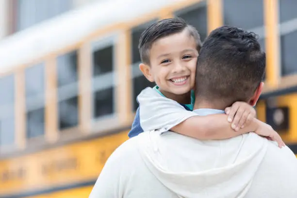 Photo of Schoolboy greets father after first day