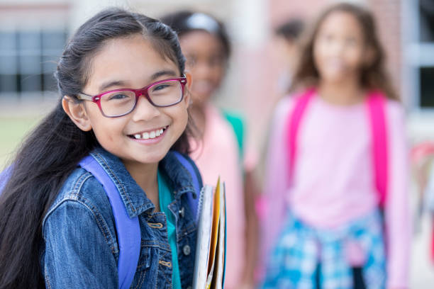 Adorable elementary age little girl smiles for camera