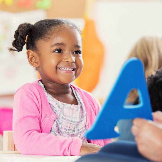istock Little girl learns alphabet during preschool 905636716