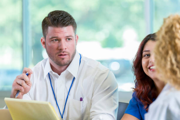 istock Serious doctor discusses something during staff meeting 905637038