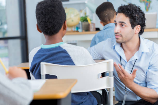 istock Middle school teacher provide individual attention to student 905637362