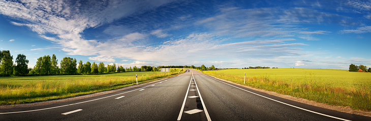 asphalt road panorama in countryside on sunny spring evening