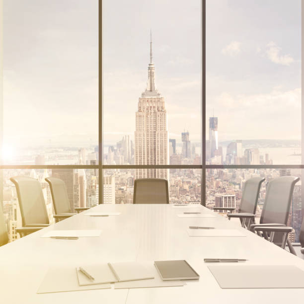 istock Large modern office desk with view at the skyscrapers 905660028