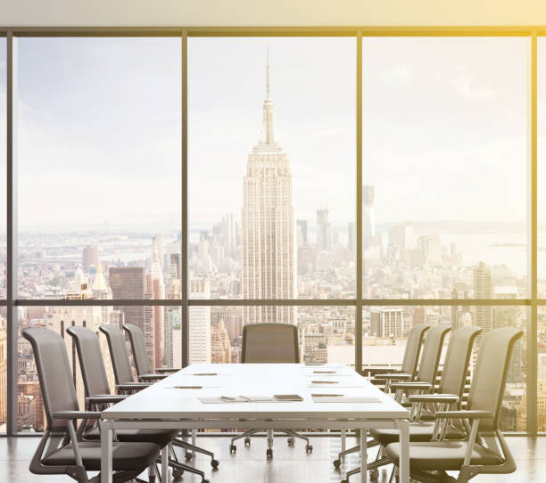 istock Large modern office desk with view at the skyscrapers 905660056