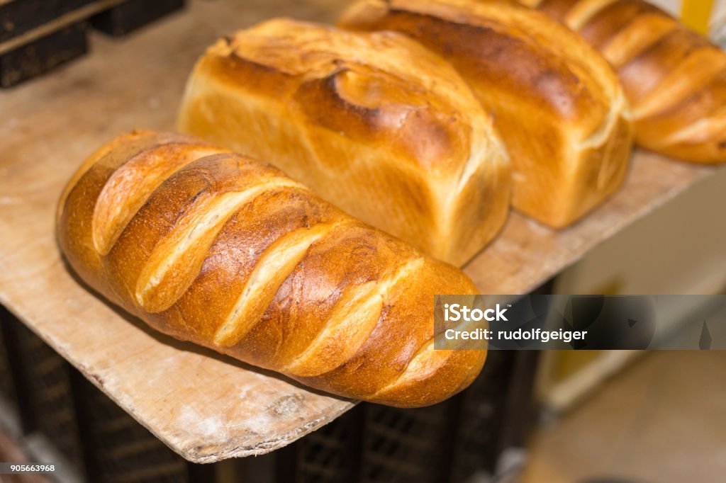 baking pastries and bread in an oven at a bakery baking pastries and bread in an oven with gold brown delicious colors at a bakery in south germany Baked Stock Photo