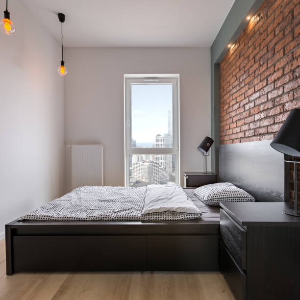 istock Stylish bedroom with brick wall 905671606